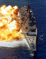 The battleship USS IOWA (BB-61) firing its Mark 7 16-inch/50-caliber guns off the starboard side during a fire power demonstration.