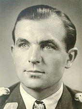 Head-and-shoulders portrait of a uniformed German air force pilot in his 30s wearing an Knight's Cross