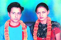 Newlyweds garlanded with marigolds