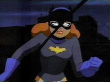  Typical depiction of Batgirl from Batman: The Animated Series: grey body-suit; blue scalloped gloves, cowl, and cape; yellow belt and bat-emblem.
