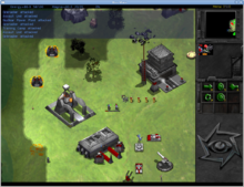 On the right is a small vertical panel witch icons and a small map. The remaining three quarters of the screen is a digital depiction of grass plain, with black and grey areas to represent unexplored regions. Three metallic looking buildings are placed on the plain, surrounded by military vehicles and personel. Certain units have gauges above them, representing their state of damage.