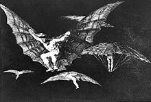 Four or five men fly with contraptions resembling bat's wings attached to their arms.
