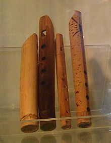 Four examples of a primitive wooden flute.