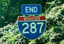 An end Interstate 287 shield with trees in the background