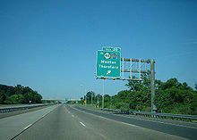 A six lane freeway with a green overhead sign reading Exit 20 to Route 44 County Route 643 Mantua Thorofare with an arrow pointing to the upper right