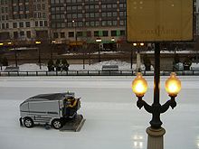 An ice resurfacing machine in action at a skating rink