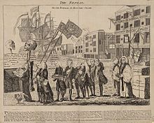 A procession of men, depicting various members of the British Parliament at the time, accompany then-Prime Minister Grenville as he carries a small coffin representing the Stamp Act near a waterfront scene with a sailing ship, cranes, bales of goods, and wharf warehouses in the background.