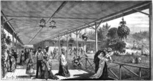 Black and white woodcut of men and women in Victorian dress on a long verandah. In the background are a large building attached to the verandah and a lake with boats on it.
