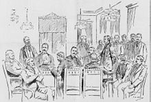 men at table in military uniforms, others standing