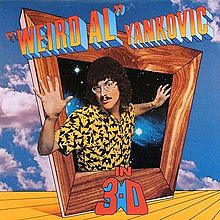 The cover for "Weird Al" Yankovic in 3-D features "Weird Al" Yankovic's upper torso protruding out of an askew box with a wooden frame. The title is written in mock three-deminsional font. The sky and a yellow floor are featured in the background.