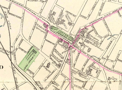 A map of downtown Waterbury on cream-colored paper, with main through streets traced in pink and the parks filled in with green