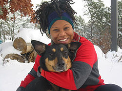 Portrait photo of an African-American woman with her dog.