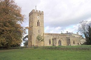 A stone church seen from the south, with a tower surmounted by a battlemented parapet on the left, and the nave with a porch and the chancel to the right