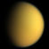 An orange spherical body is half illuminated from the right. The terminator is running from the top to bottom slightly to the left off the center. Both limb and terminator are fuzzy due to light scattering in the atmosphere.