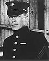 Head and shoulders of square-jawed man in circa 1920 formal U.S. Marine uniform.