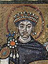 Mosaic of mustachioed, curly-haired man wearing crown and surrounded by halo