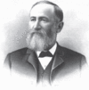 Older man with gray beard and dark suit with bow tie and white shirt