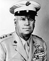 Head and shoulders of man in circa 1940 U.S. Marine khaki uniform, wearing many campaign ribbons.