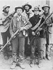 Boer Commando men dressed in mufti armed with rifles