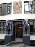 A portal with the front of two elephants beside the door.