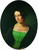 Portrait of a young lady. She is wearing a dress under a coat. She is looking to the left, somewhat smiling.