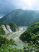 A picture of river surrounded by high cliffs