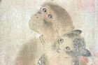 A faded, landscape oriented fragment of a painting depicting a black and white cat and a monkey staring at each other and clinging to one another.