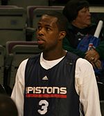 A basketball player wearing a black jersey with the word "PISTONS" and the number 3 on the front