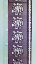 Vertical section of filmstrip, showing four-and-a-half frames, each of which reads, "Sea Power for Security. The End." Alongside the frames runs a continuous vertical white band of continuously fluctuating width.