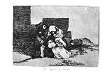 Huddled behind the ruins of a building, two women, one with a child in her arms, lay a third to her permanent rest in the ground. To the rear another woman lies dead.