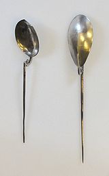 two longhandled spoons, the "handle" is a tapering metal spike