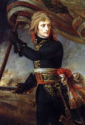 Three-quarter length depiction of Bonaparte, with black tunic and leather gloves, holding a standard and sword, turning backwards to look at his troops