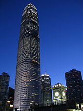 A brightly lit tall skyscraper at night.
