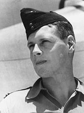 Outdoor head-and-shoulders portrait of man in tropical military uniform with forage cap