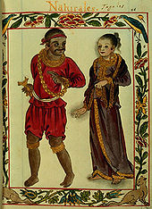 An elaborate border frames a full length illustration one would associate with a manuscript of a man and woman. The dark-skinned man dressed in red tunic, breeches, and bandanna and wearing a gold chain is looking pleasantly over his shoulder in the direction of the fair woman who, garbed in a dark gold-fringed dress that covers the length of her body except her bare feet, has the faintest hints of a smile.