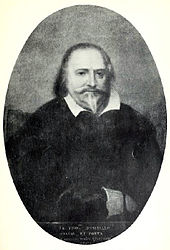  Artist's representation of a man looking straight out of the picture, with dark receding hair and pointed beard. He is wearing dark clothing with a loose white collar.