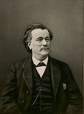 Photograph of a man, with receding hairline and grey moustache. He is dressed in a formal jacket and waistcoat, typical of Victorian fashion.