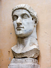 A marble bust of an expressionless man with his eyes wide open staring blankly upward
