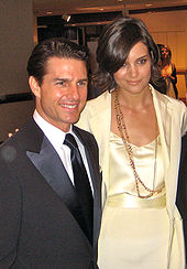 Holmes and Tom Cruise together, her hand on his shoulder.