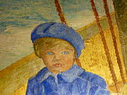 Bust-length view of small blue-eyed child in blue coat and cap sitting in boat