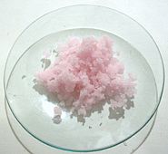 alt2=Some clumps of a pale pink, translucent, crystalline solid, on a laboratory watch glass
