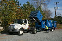 An International DuraStar used to transport Dumpsters.