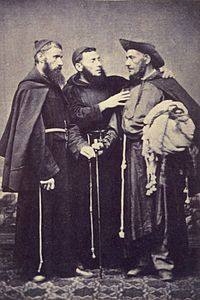 A photograph showing 3 standing men wearing religious habits