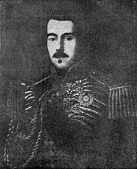 Lithograph depicting a dark-haired man with moustache wearing a heavily embroidered military tunic with epaulettes, sash of office and several medals and orders at his neck