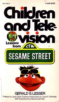 Book cover: White background, with the words "Children and Television" in bold black letters. A small circle with the face of an unknown Muppet character separates the word "television", and the words "Lessons from" appear in smaller black print. Below that is the famous Sesame Street" street sign, and below that is the face of the Muppet Ernie.  The author of the book, Gerald Lesser, is written at the bottom.