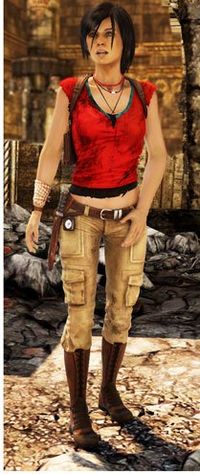 A tan woman stands in the foreground, wearing a red shirt which covers her torso, but leaves her shoulders and stomach bare. She also wears khaki pants, a brown leather belt and boots, and a large bracelet of white beads on her right hand. She has a red and a black necklace, dark hair, very light blue eyes, and an open mouth. In the background is rubble and the edge of an archway.