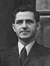 "Black and White head and shoulder shot of 30's white male with thick black hair, and a three piece suit from the 1940s."
