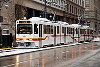 Denver LRVs in snow, on Stout St in downtown.jpg