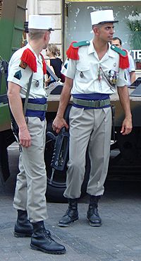 Photograph of two members of the French Foreign Legion dressed in their traditional uniforms.