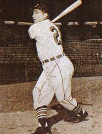 A sepia-toned image of a man in a baseball uniform holding a baseball bat over his left shoulder